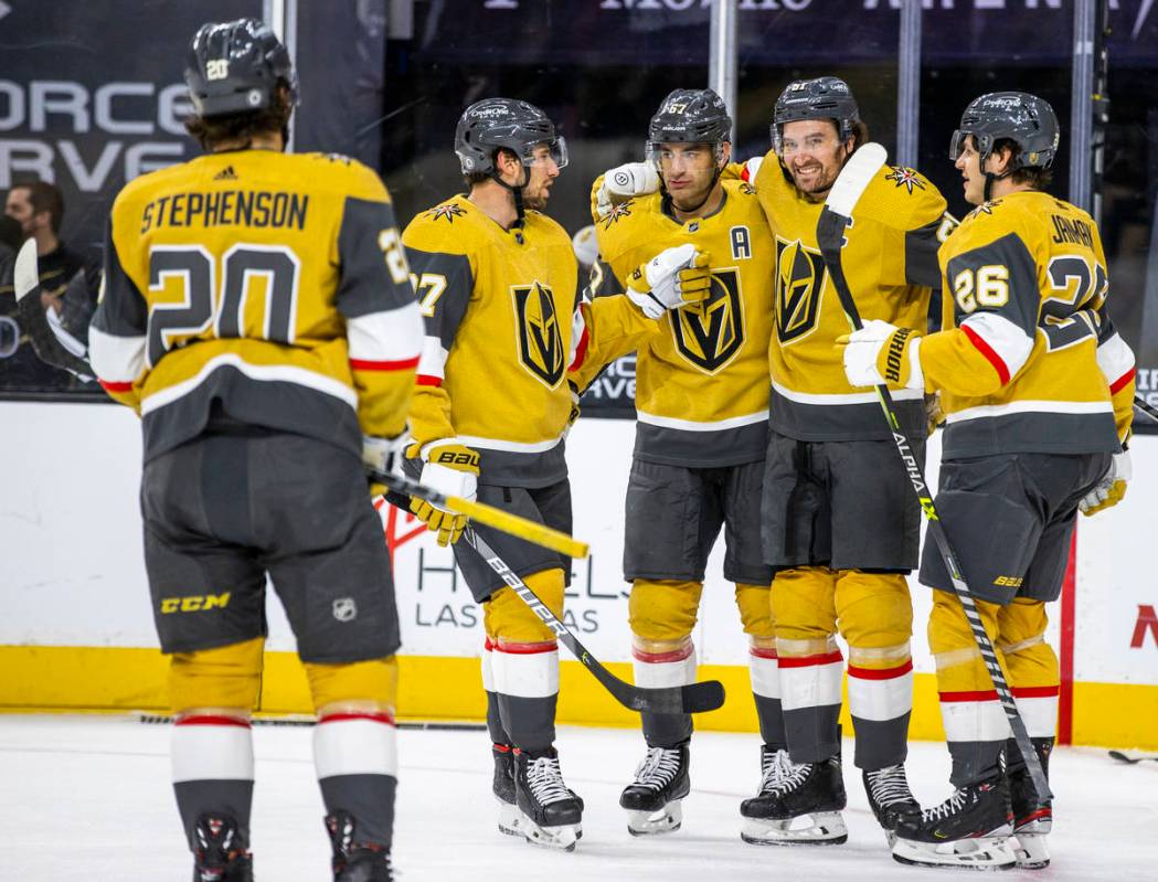 Golden Knights right wing Mark Stone (61) is congratulated by teammates after scoring on San Jo ...