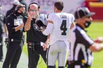 Las Vegas Raiders offensive line coach Tom Cable speaks to quarterback Derek Carr (4) during th ...