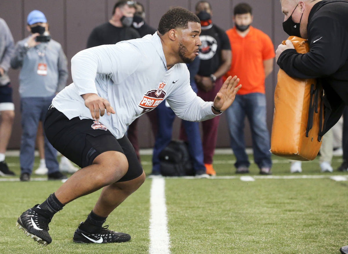 In this March 26, 2021, file photo, Christian Darrisaw runs a drill Virginia Tech pro day, atte ...