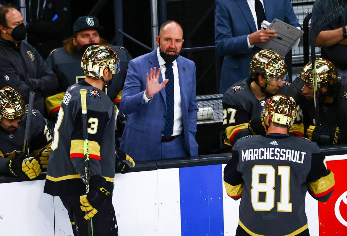 Golden Knights head coach Pete DeBoer talks with his team during the third period of an NHL hoc ...