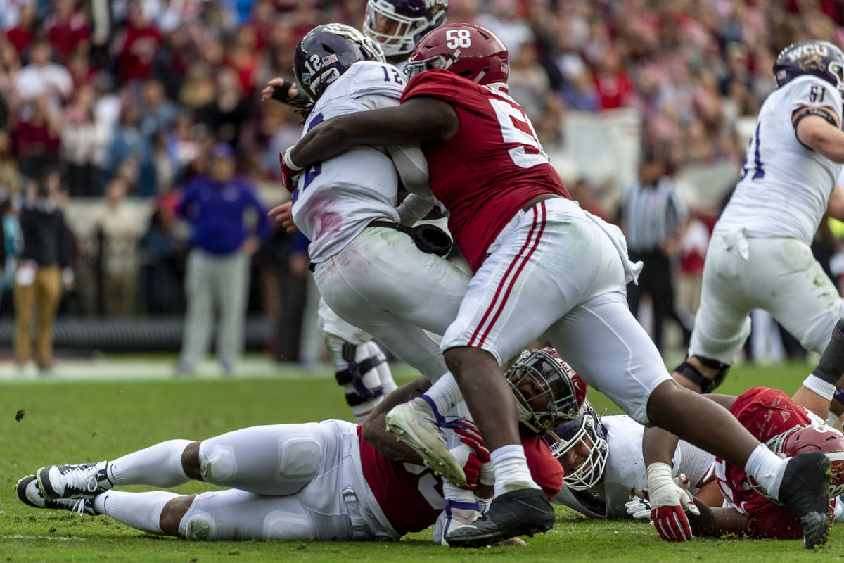 FILE - Alabama defensive lineman Christian Barmore (58) sacks Western Carolina quarterback Tyri ...