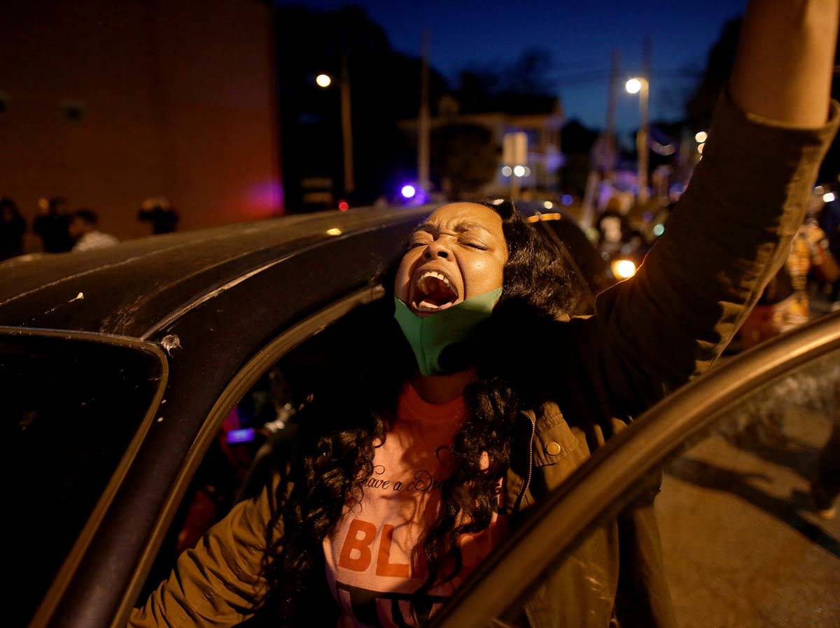 A demonstrator yells from her car as protesters took to the streets in Elizabeth City, N.C., on ...