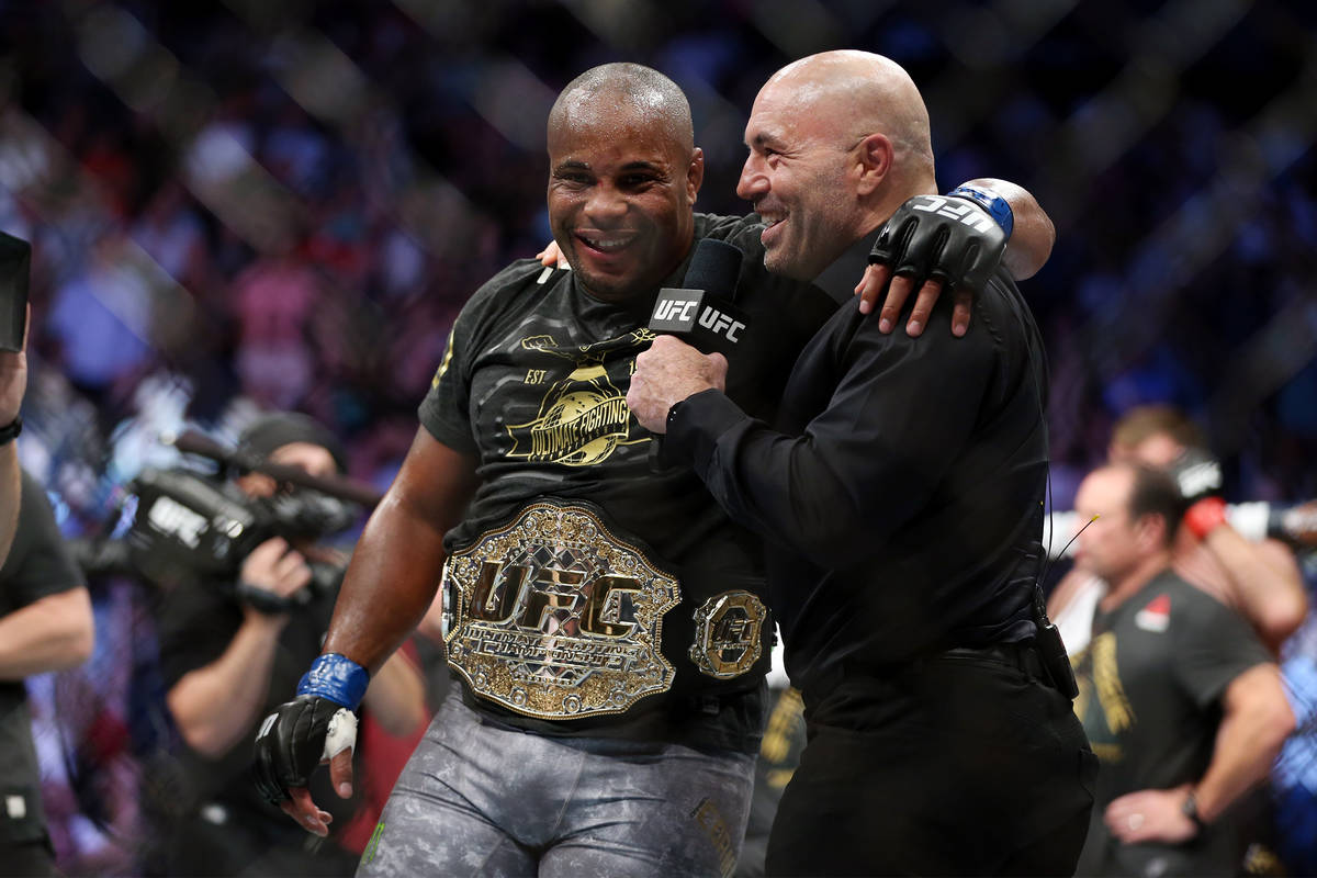 Daniel Cormier, left, with UFC commentator Joe Rogan, celebrates his knockout win against Stipe ...