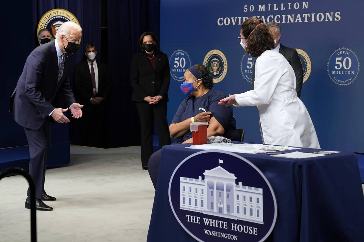 In this Feb. 25, 2021, file photo President Joe Biden talks to Linda Bussey before she received ...