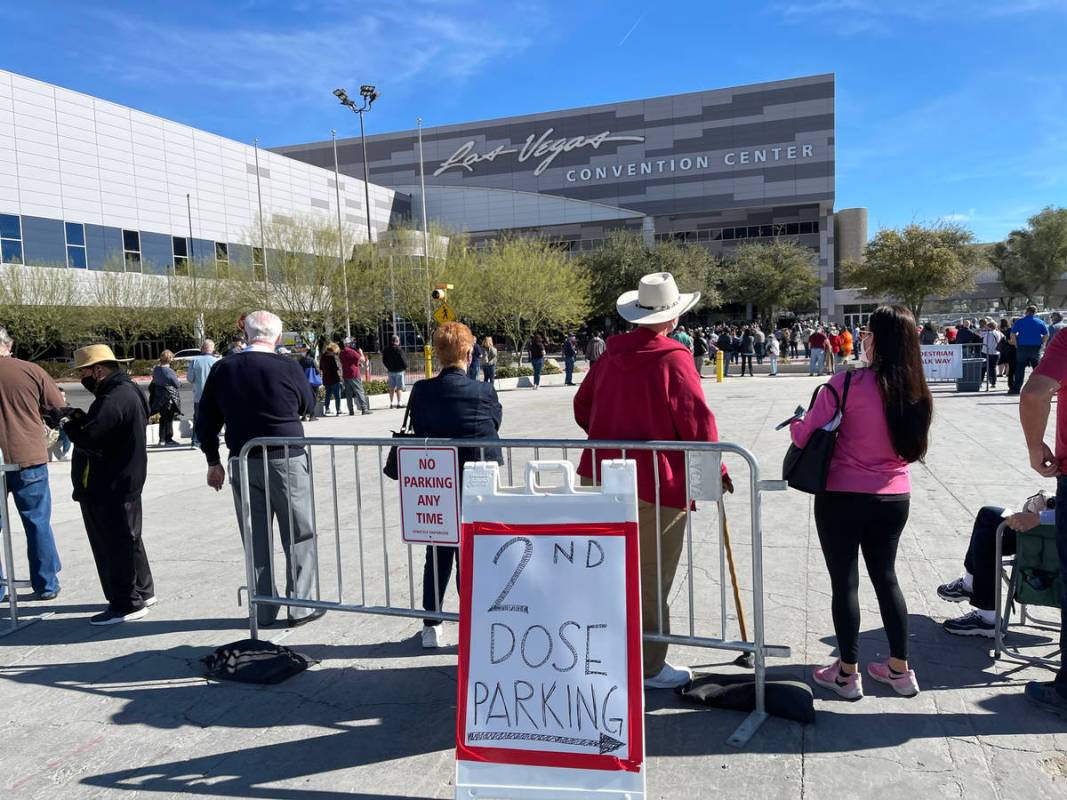 In this Feb. 11, 2021, file photo, people line up for the second dose of the COVID-19 vaccine o ...