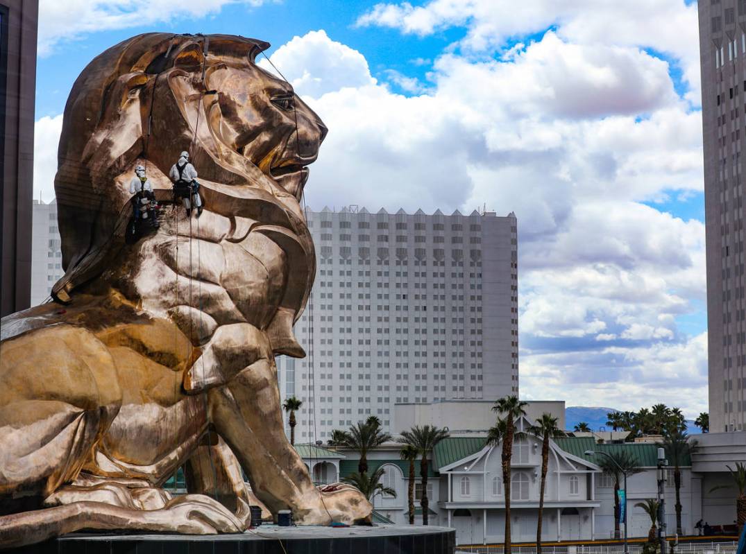 Workers buff the MGM lion statue outside the MGM Grand on Tuesday, April 27, 2021, in Las Vegas ...