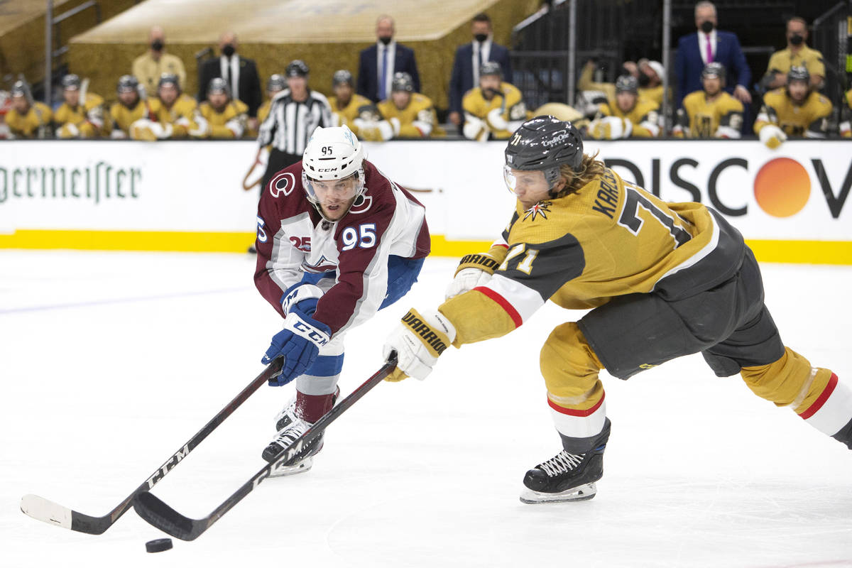 Avalanche left wing Andre Burakovsky (95) and Golden Knights center William Karlsson (71) compe ...