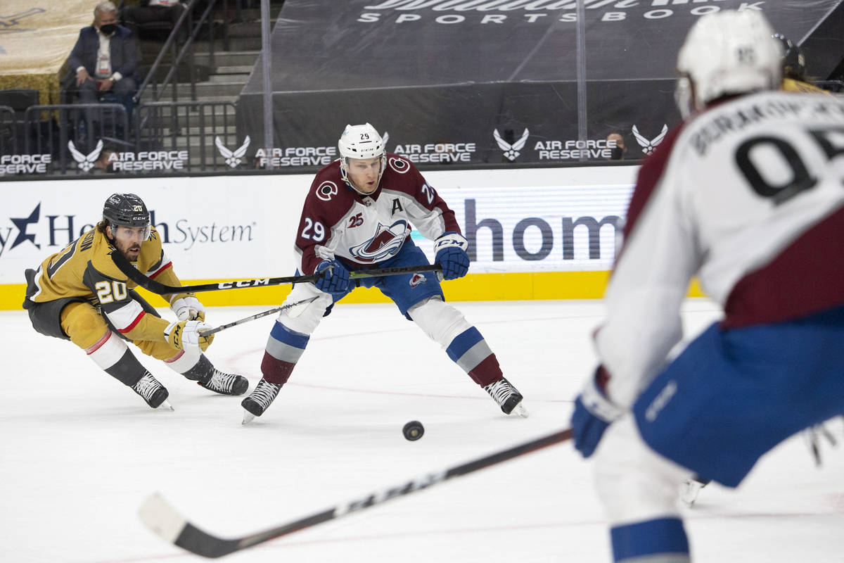 Golden Knights center Chandler Stephenson (20) and Avalanche center Nathan MacKinnon (29) compe ...