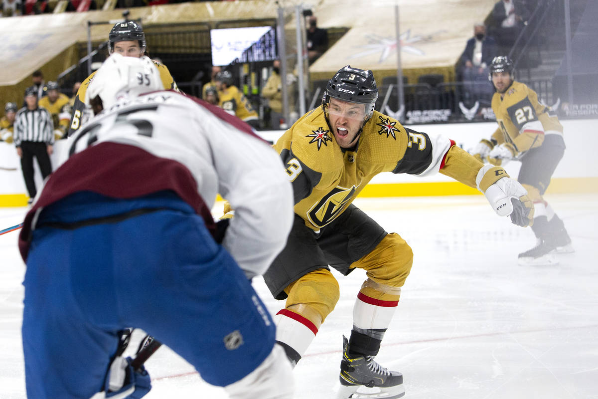 Golden Knights defenseman Brayden McNabb (3) competes for the puck with Avalanche left wing And ...