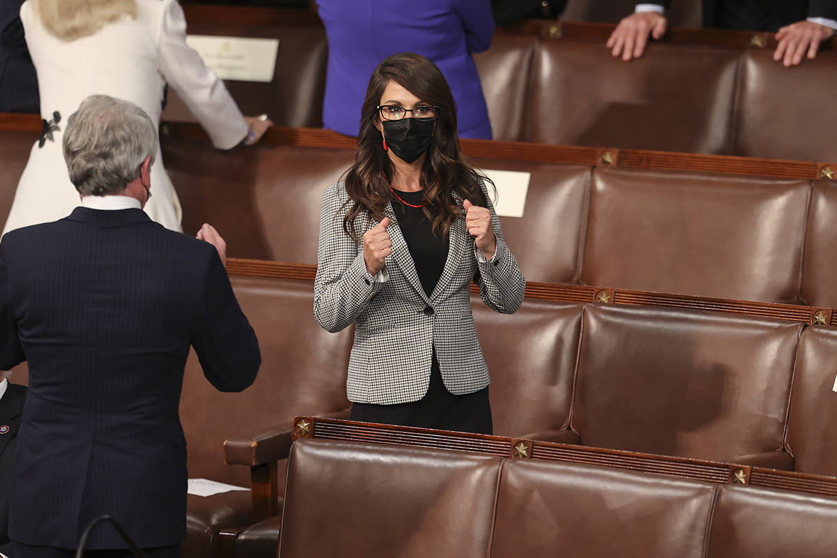 Rep. Lauren Boebert, R-Colo., makes two fists as she arrives before President Joe Biden speaks ...