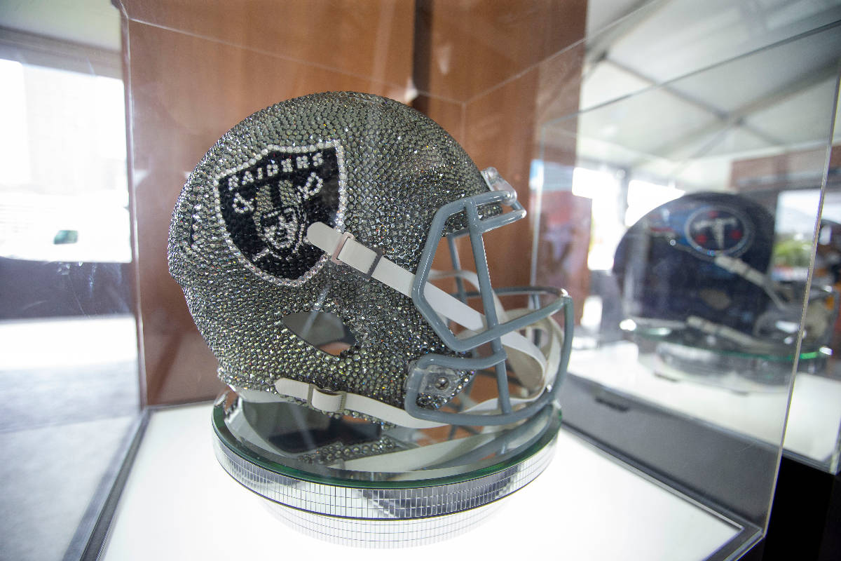 A bedazzled Raiders helmet is on display in the NFL Draft Experience locker rooms near FirstEne ...