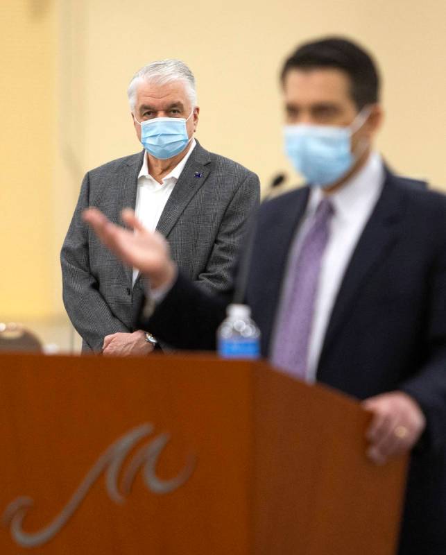 Gov. Steve Sisolak listens to Brin Gibson, chair of the Gaming Control Board, during an update ...