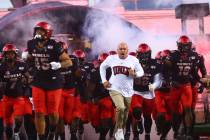 UNLV Rebels head coach Tony Sanchez leads his team onto the field before playing Arkansas Stat ...