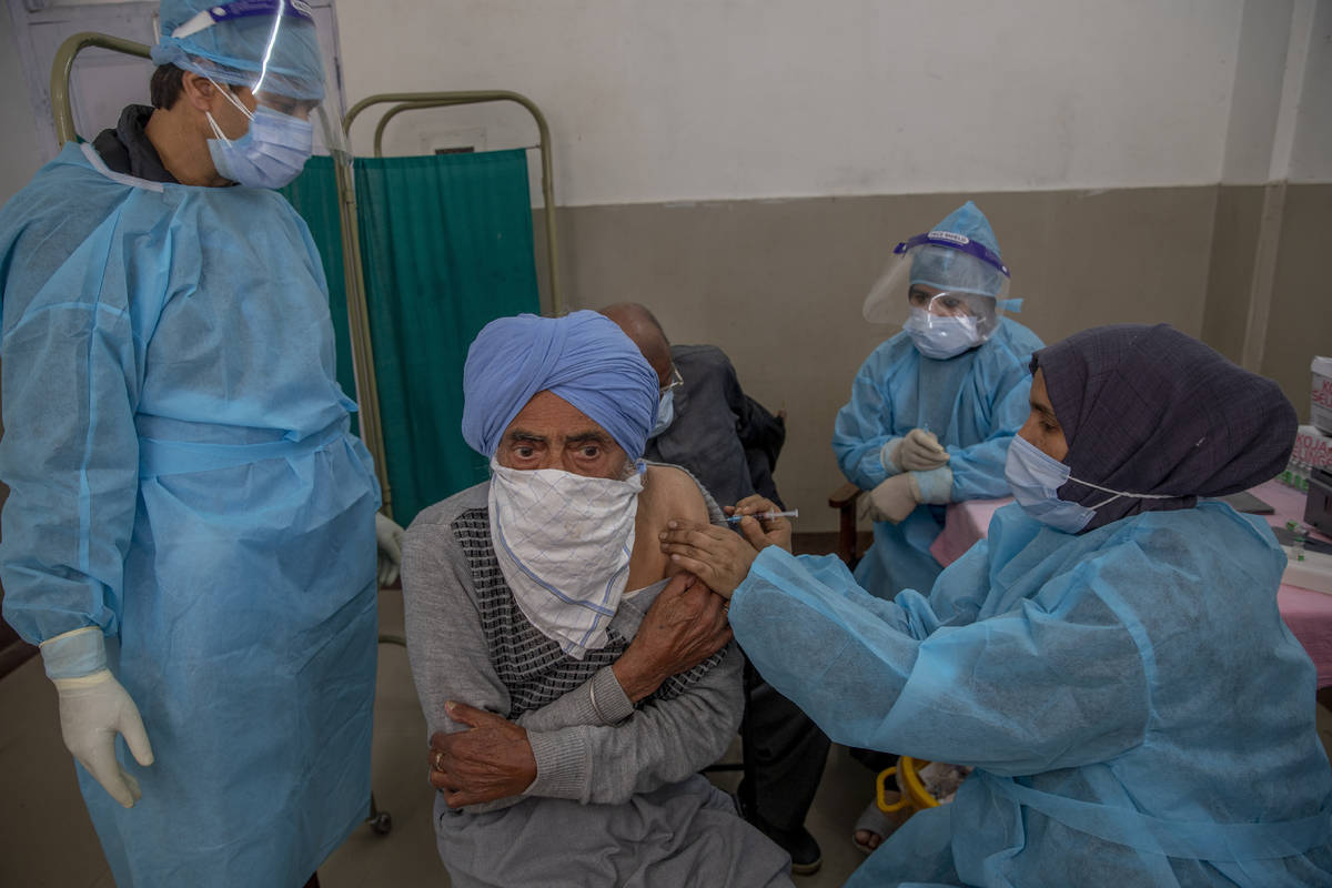 A Kashmiri man receives the COVISHIELD vaccine for COVID-19 at a primary health center in Srina ...