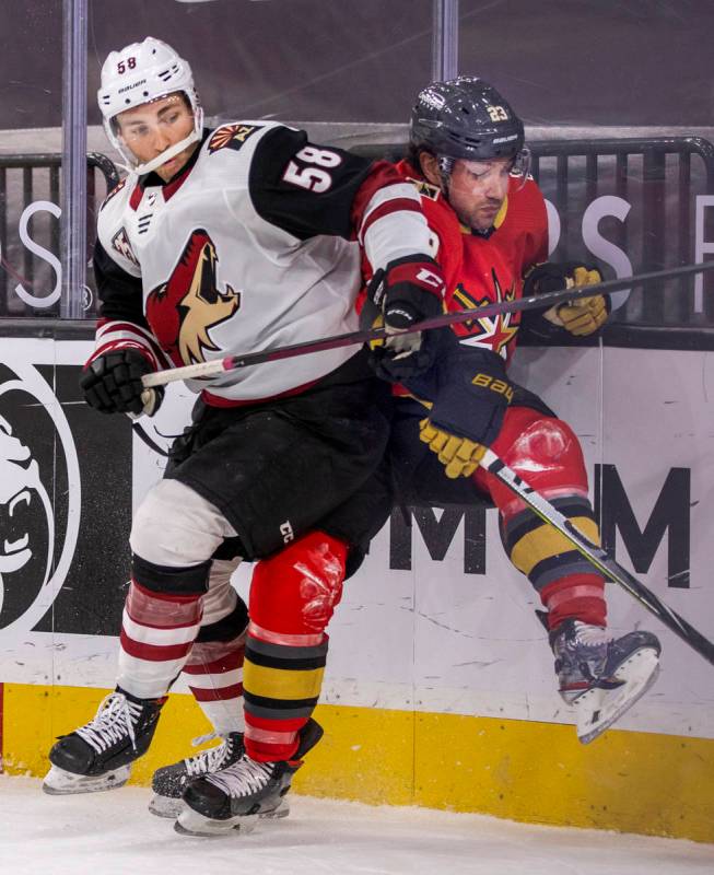 Arizona Coyotes left wing Michael Bunting (58) battles with Golden Knights defenseman Alec Mart ...