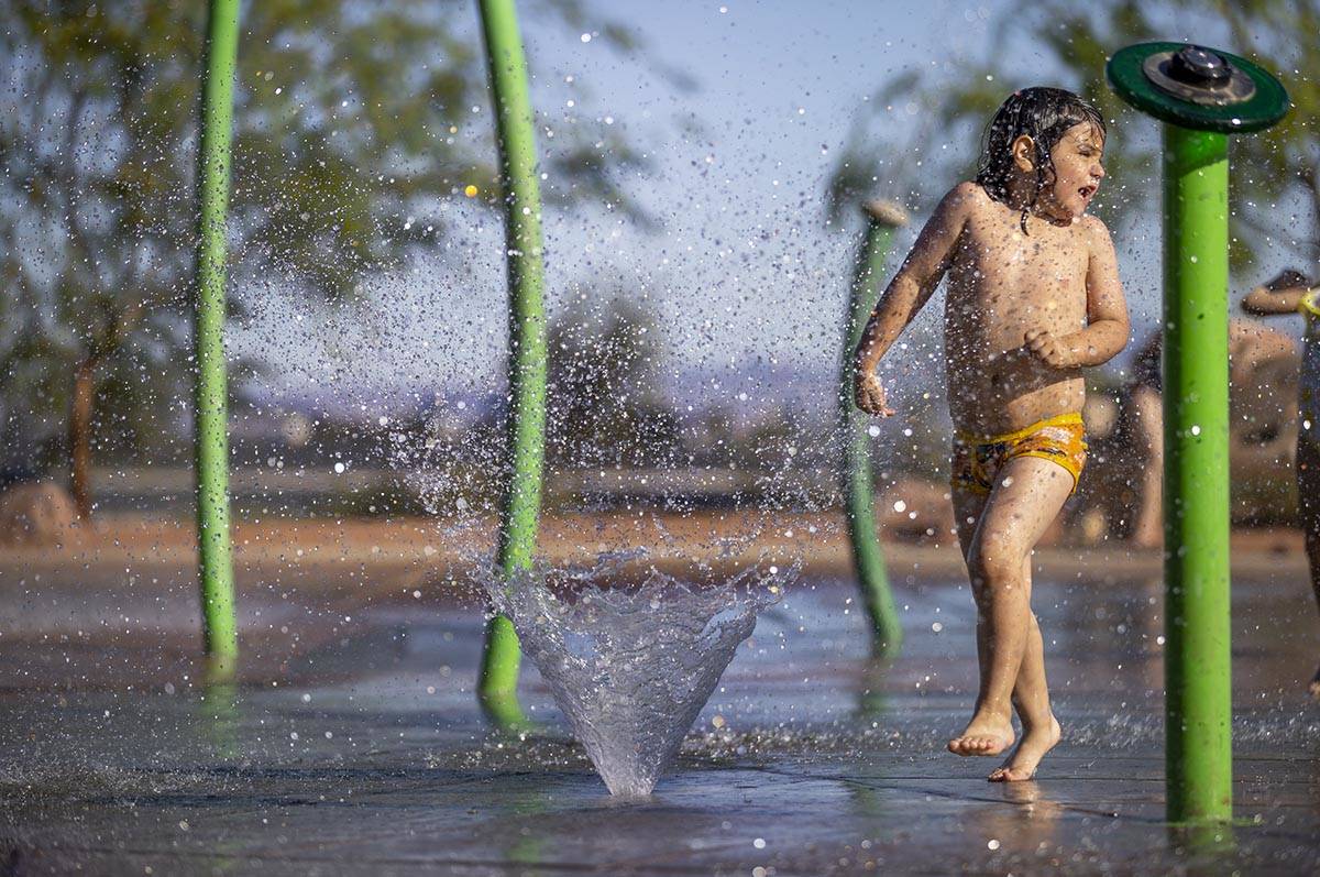 Bodhi Brown, 5, is sprayed from a fountain while playing in the water park at Bill Briare Famil ...