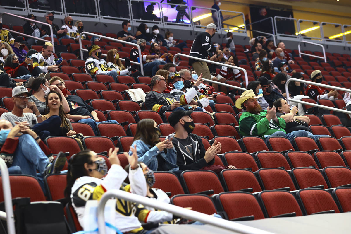 Golden Knights fans cheer at the start of an NHL hockey game against the Arizona Coyotes at Gil ...