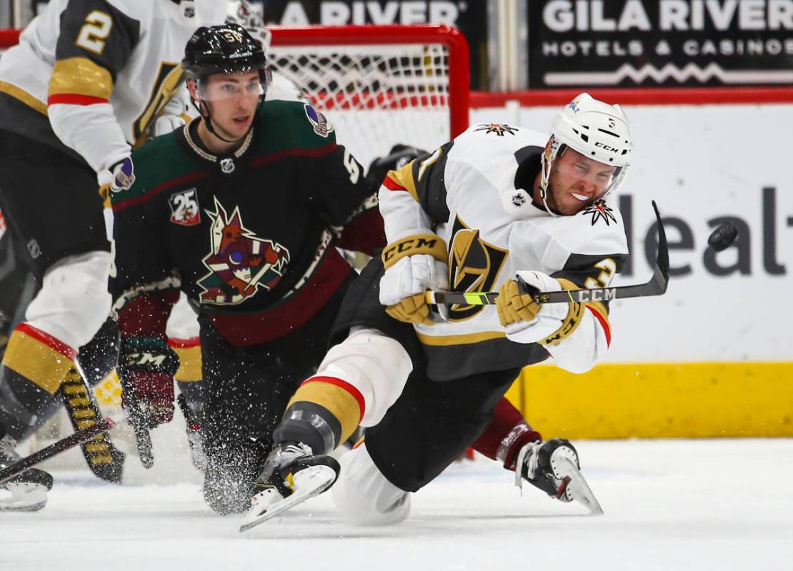 Golden Knights' Brayden McNabb (3) passes the puck in front of Arizona Coyotes' Michael Bunting ...