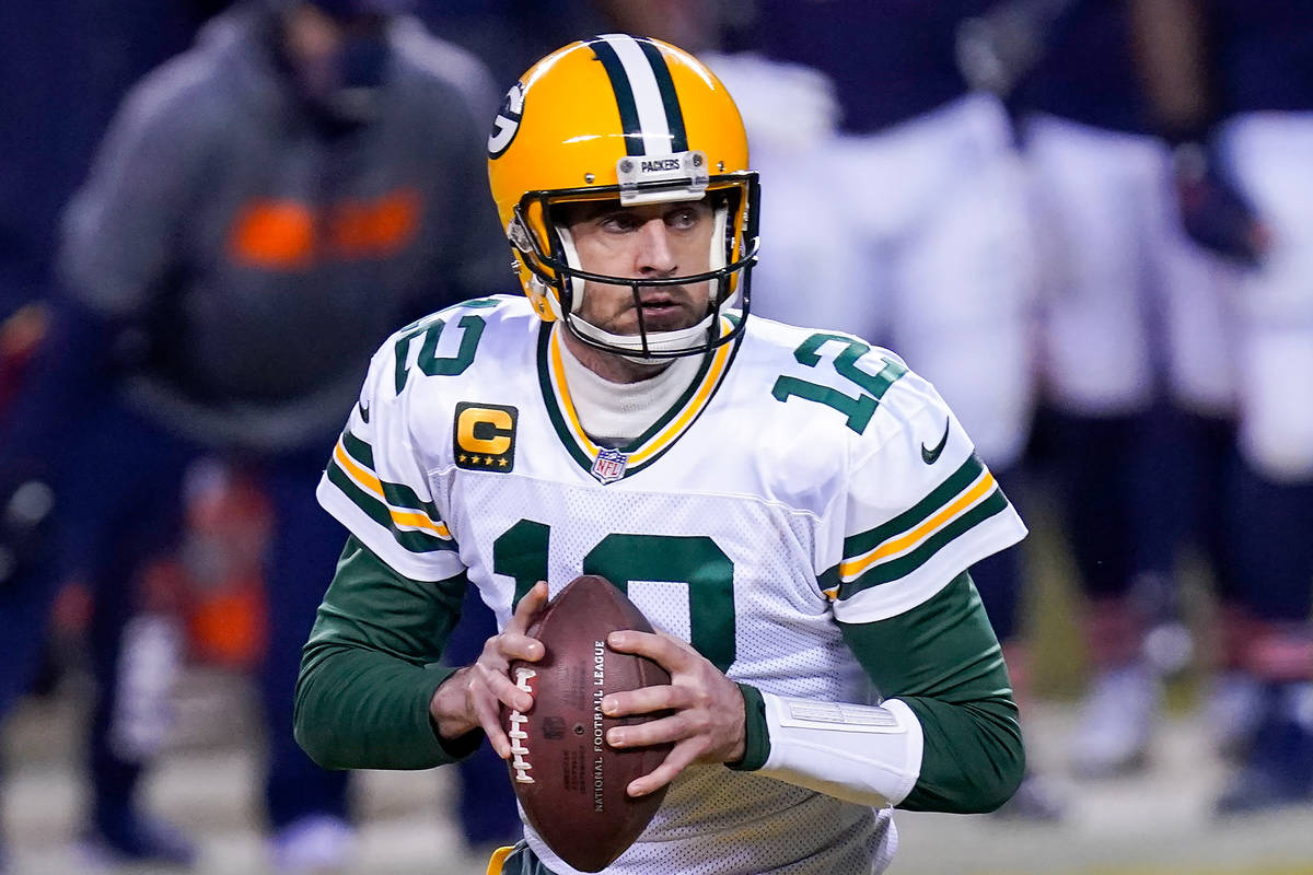 Green Bay Packers' Aaron Rodgers scrambles during the first half of an NFL football game agains ...