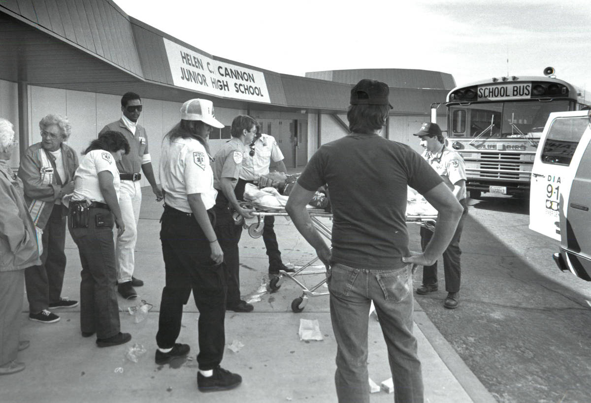 Students affected by the chlorine leak stand outside Helen C. Cannon Junior High School on May ...