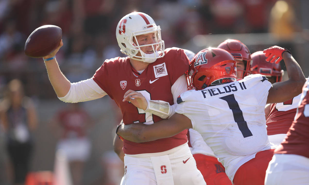 Stanford quarterback K.J. Costello, left, is pressured by Arizona's Tony Fields II (1) during t ...