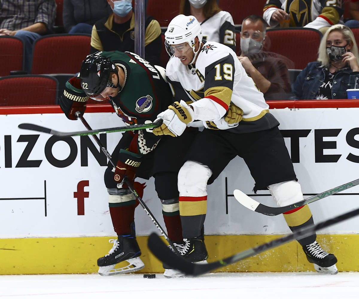 Golden Knights' Reilly Smith (19) and Arizona Coyotes' Johan Larsson (22) battle for the puck d ...