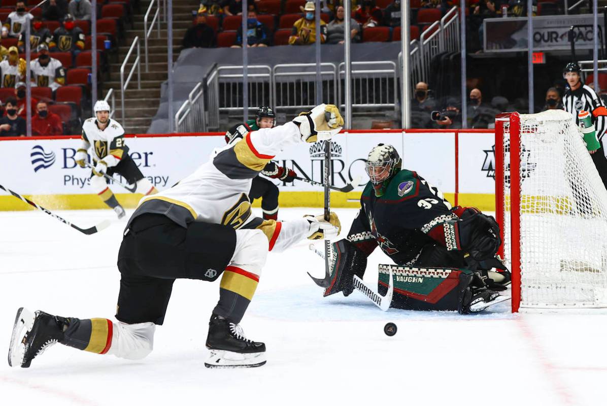 Golden Knights' Max Pacioretty, left, attempts a shot against Arizona Coyotes goaltender Darcy ...