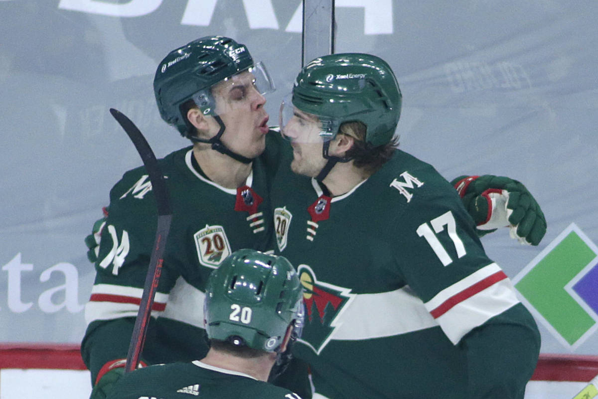 Minnesota Wild center Joel Eriksson Ek (14) and Minnesota Wild left wing Marcus Foligno (17) ce ...