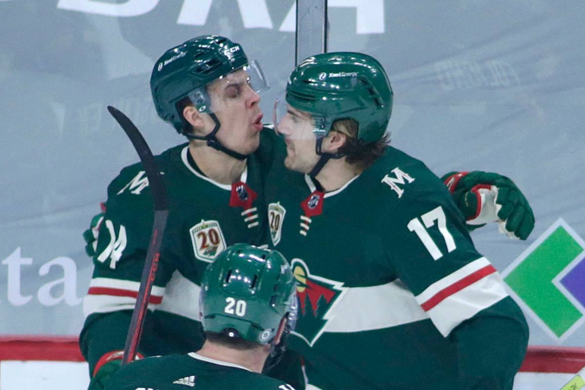 Minnesota Wild center Joel Eriksson Ek (14) and Minnesota Wild left wing Marcus Foligno (17) ce ...