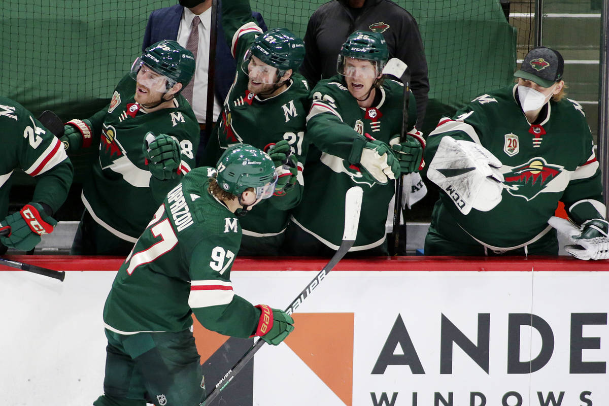 Minnesota Wild left wing Kirill Kaprizov (97) is congratulated by defenseman Ian Cole (28), def ...