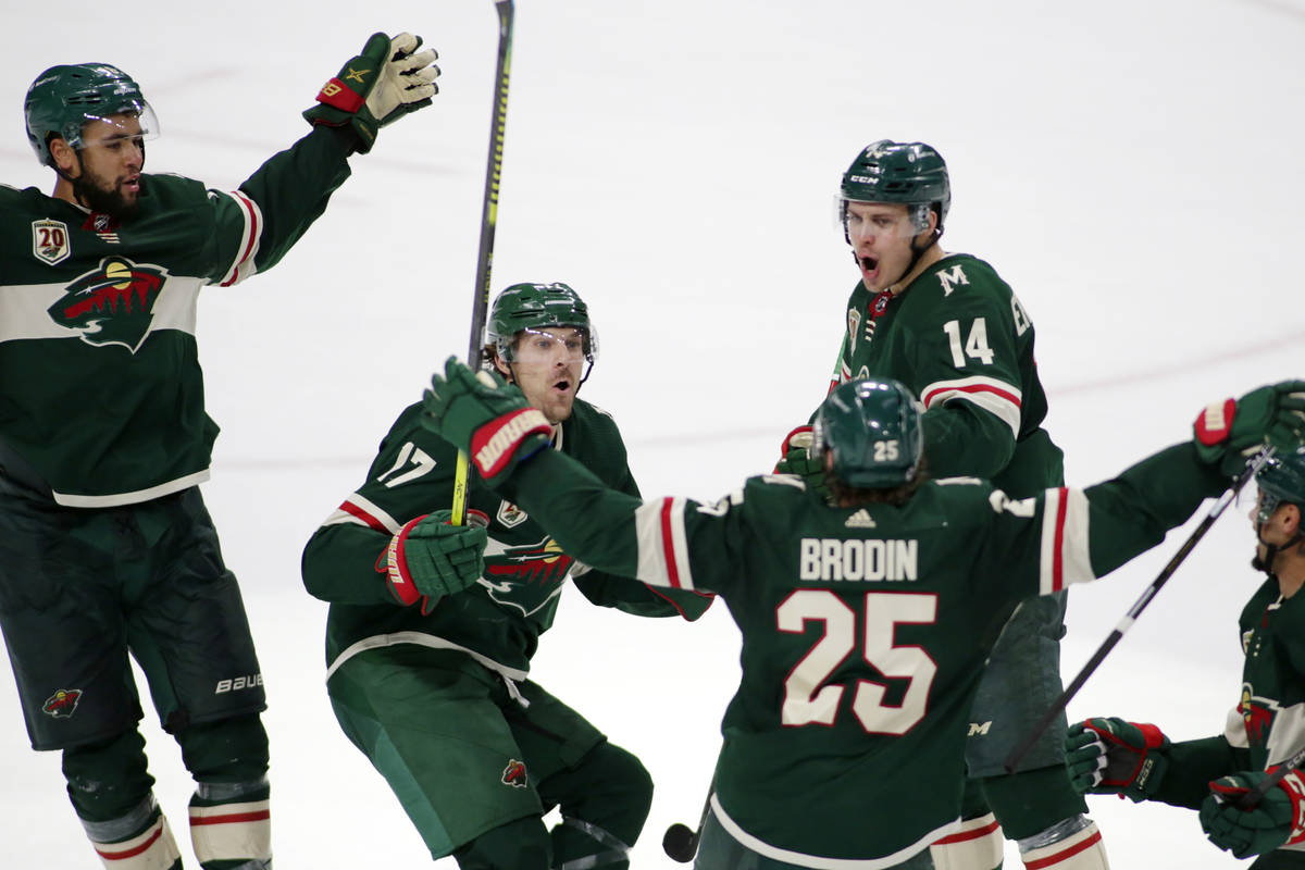 Minnesota Wild defenseman Jonas Brodin (25) is congratulated by teammates Minnesota Wild left w ...