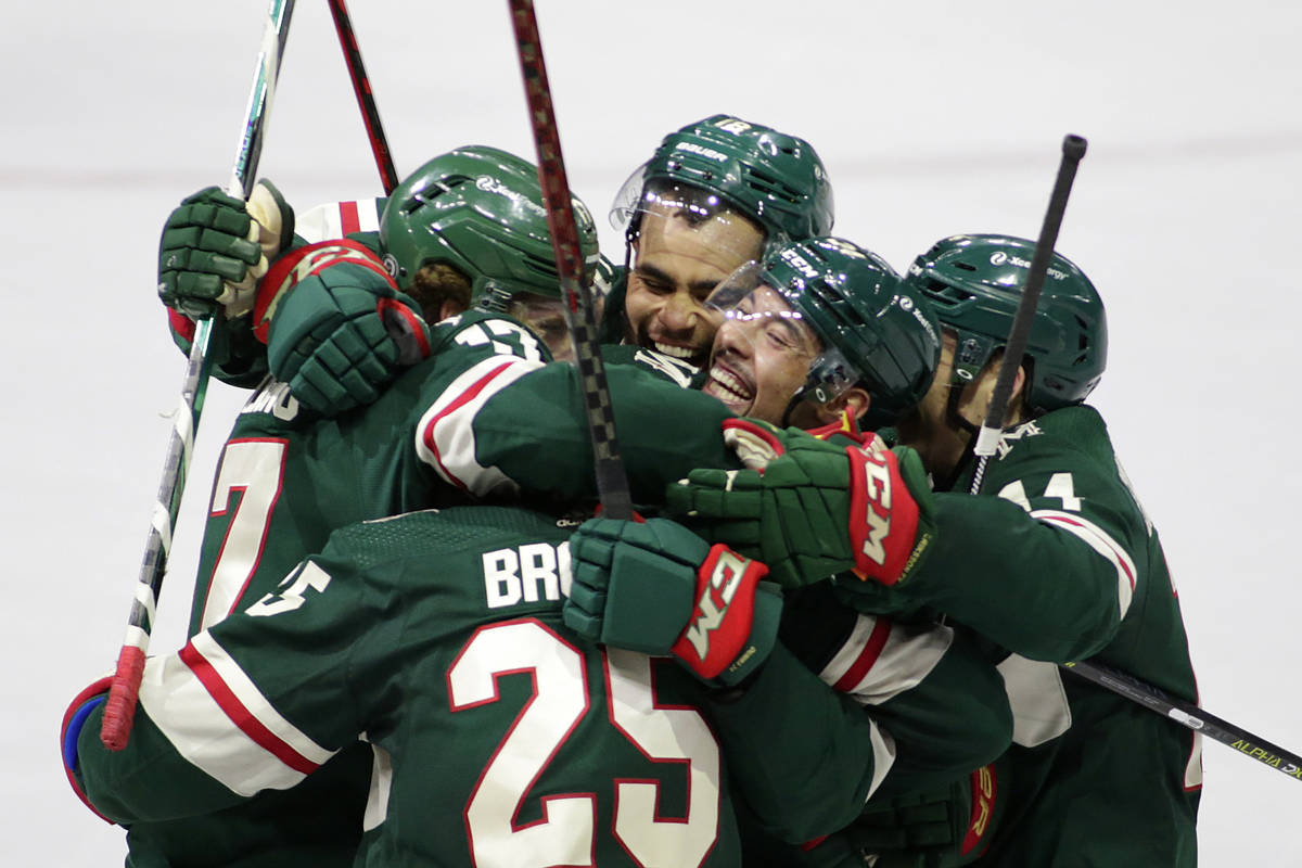 Minnesota Wild defenseman Jonas Brodin (25) is congratulated by teammates Minnesota Wild left w ...