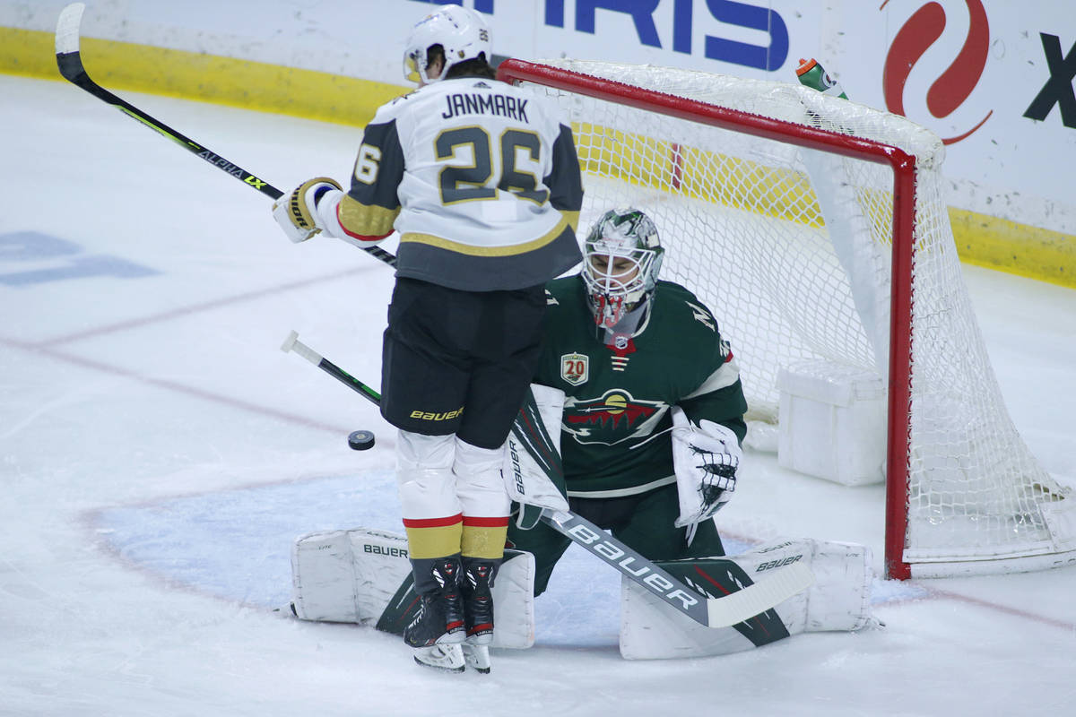 Minnesota Wild goaltender Cam Talbot (33) is blocked by Vegas Golden Knights center Mattias Jan ...