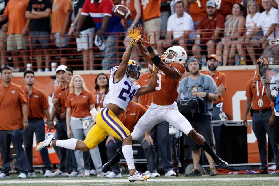 LSU cornerback Derek Stingley Jr., left, breaks up a pass intended for Texas wide receiver Coll ...