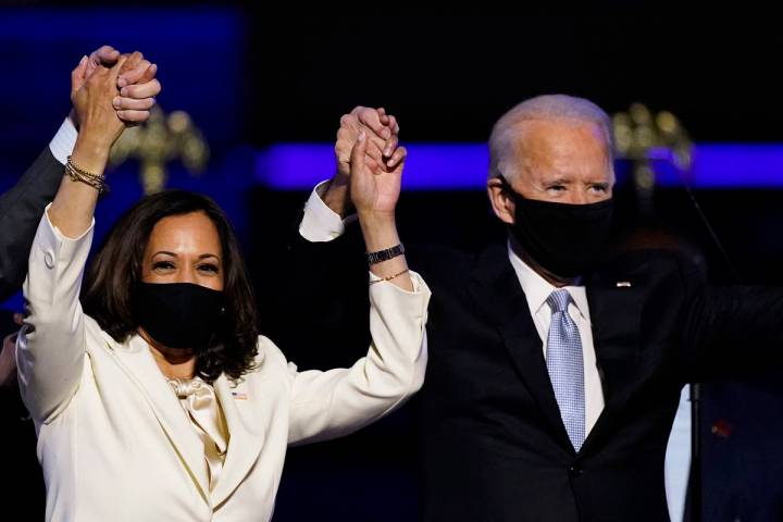 Vice President Kamala Harris holds hands with President Joe Biden. (AP Photo/Andrew Harnik, File)