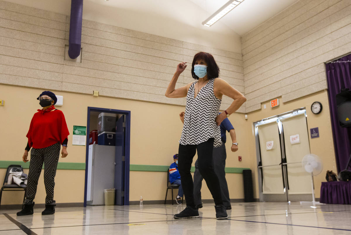 Terry Harris, 78, center, participates during a line dancing class at the West Flamingo Senior ...