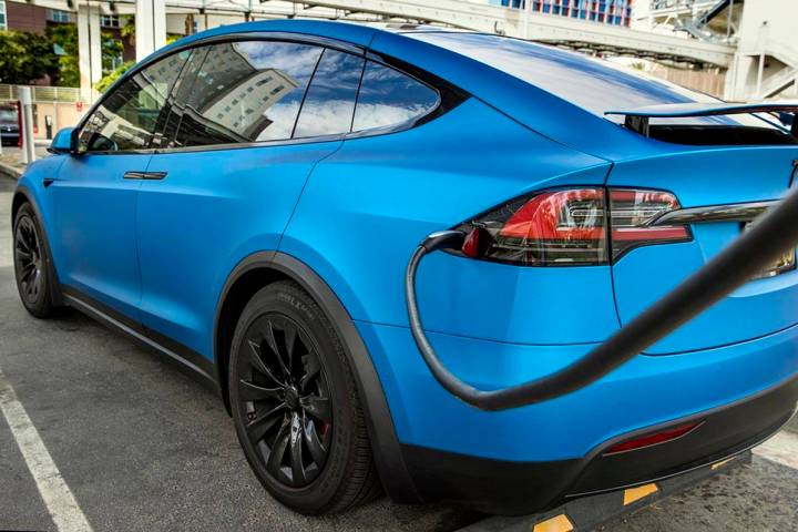 A car is plugged in at the Tesla Supercharger station near The LINQ and High Roller on Friday, ...