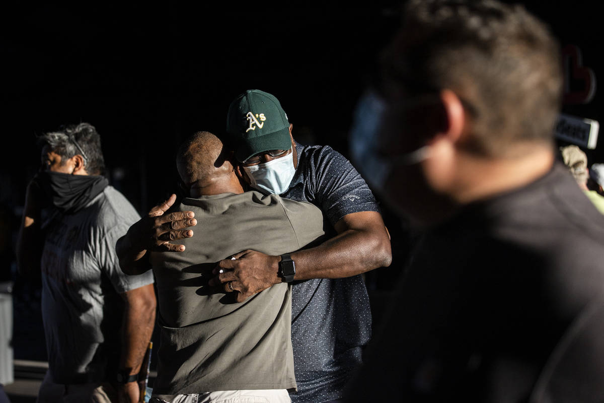 Mike Reed, facing, hugs friend John Gregory before the start of a Triple-A baseball game betwee ...