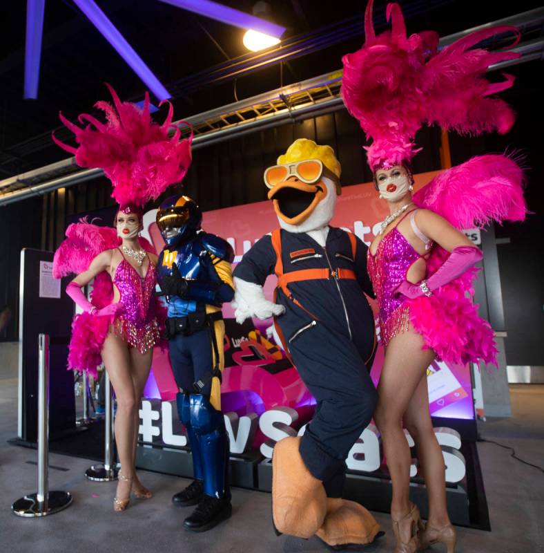 Aviator, second from left, and Spruce the Goose pose with showgirls before the start of a Tripl ...