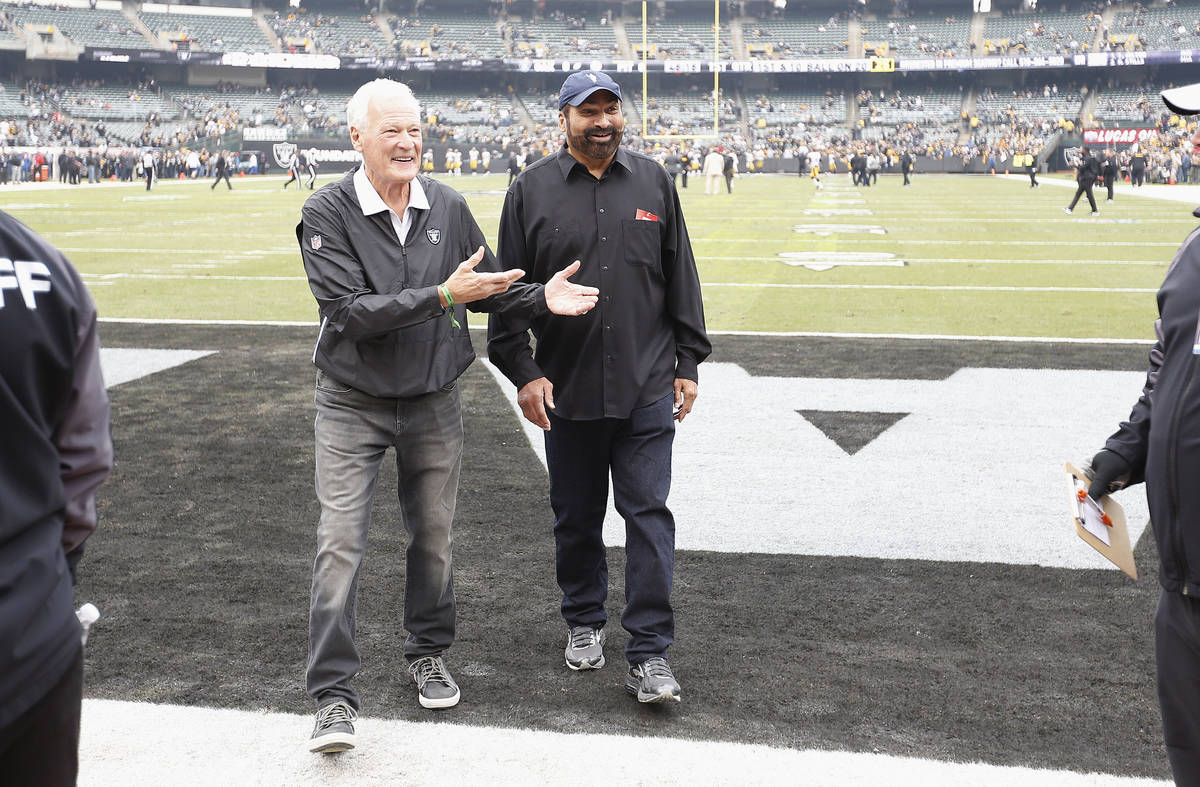 Former Oakland Raiders linebacker Phil Villapiano, left, walks with former Pittsburgh Steelers ...