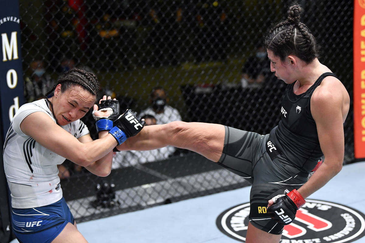 Marina Rodriguez of Brazil kicks Michelle Waterson in a flyweight fight during the UFC Fight Ni ...