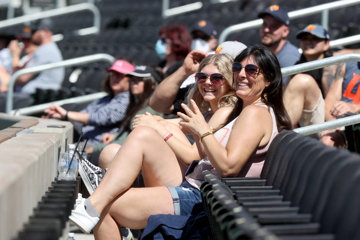Laurel Grantham and her daughter Kaitlyn, 15, soak in the sun at Las Vegas Ballpark as the Las ...