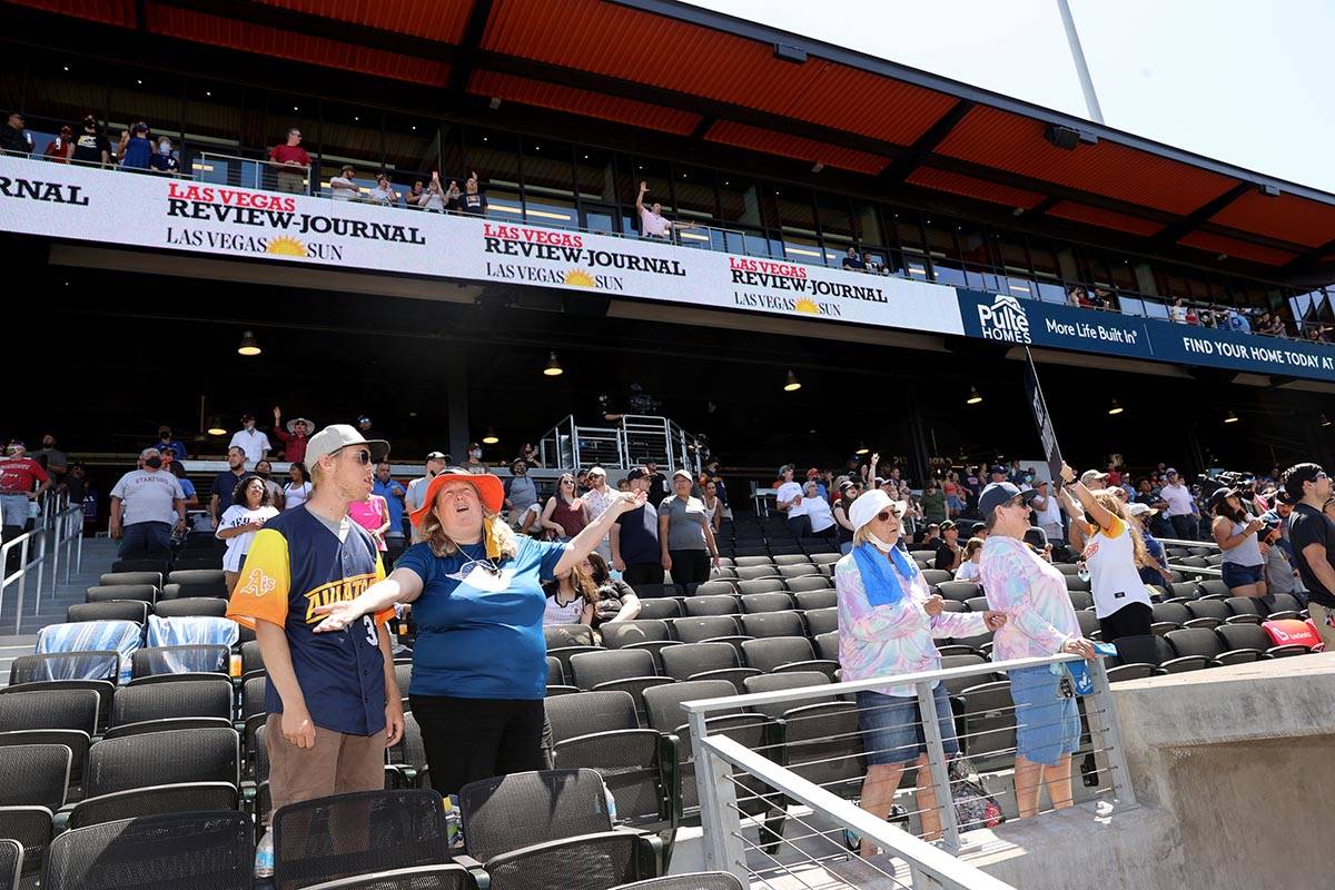 Maria Engdahl and her son Mitchell, 17, sing "Take Me Out to the Ballgame" during the seventh i ...