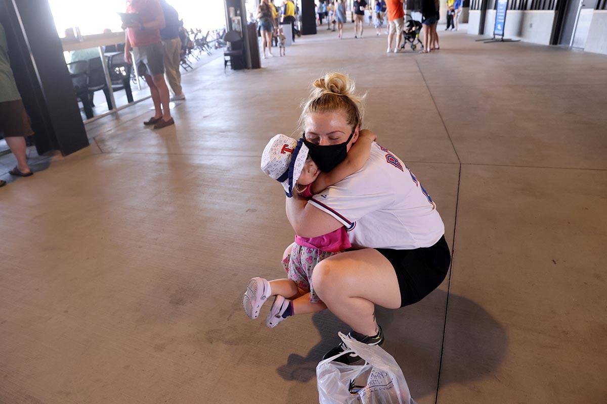 Rebecca Johnson gets a hug from her daughter Raylin, 2, on the concourse at Las Vegas Ballpark ...