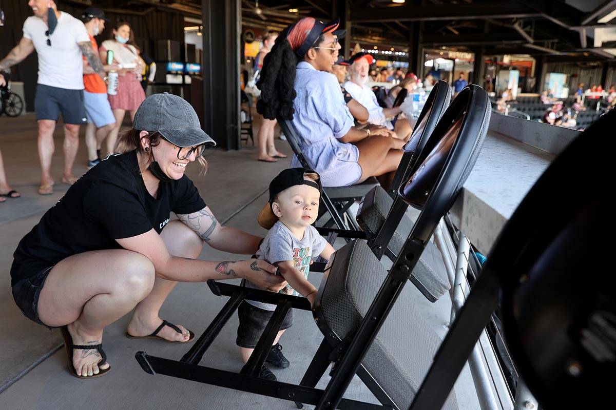 Mikayla Stevens and her son Maxtyn, 10 months, watch from the concourse at Las Vegas Ballpark b ...