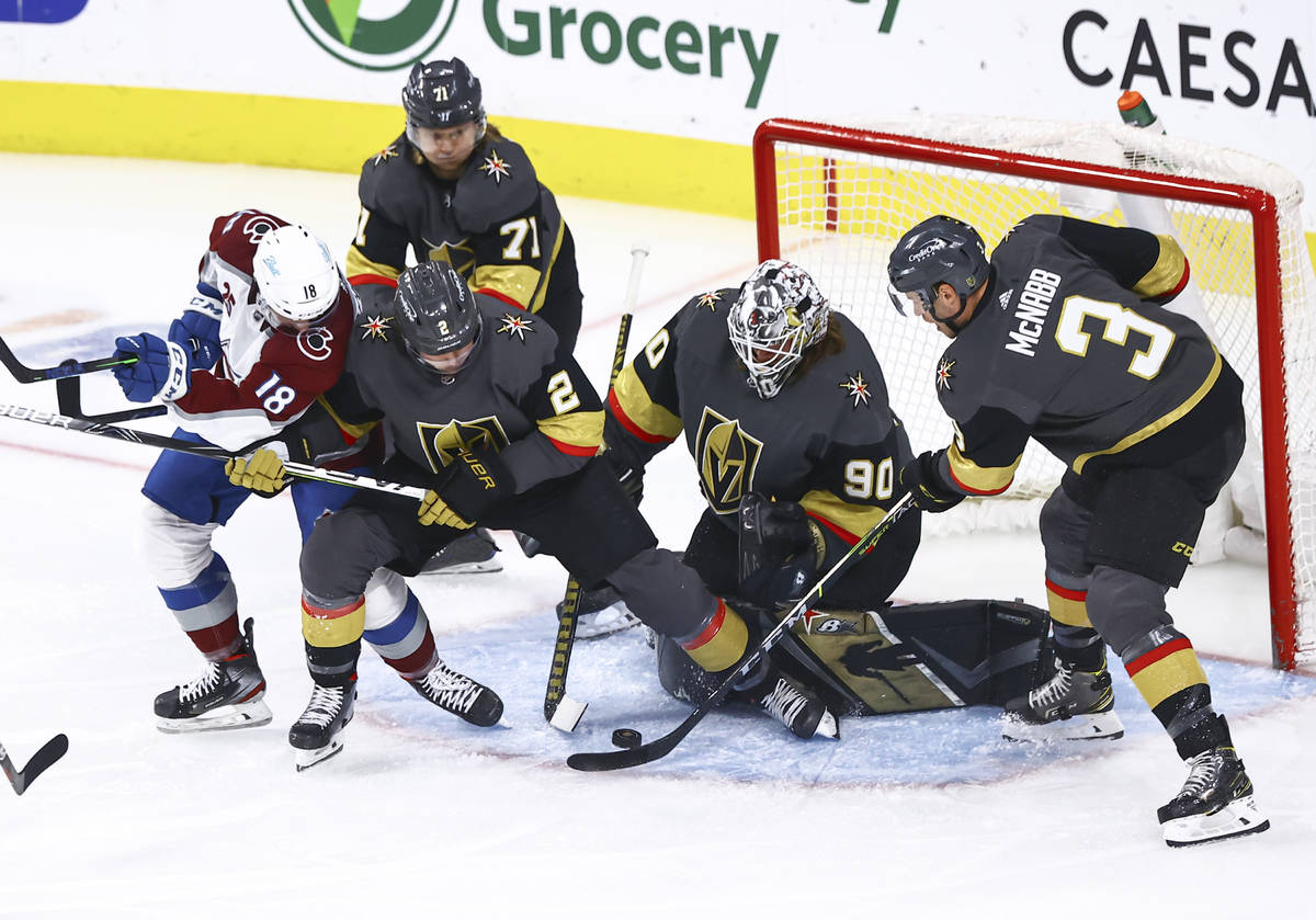 Golden Knights goaltender Robin Lehner (90) and defensemen Zach Whitecloud (2) and Brayden McNa ...