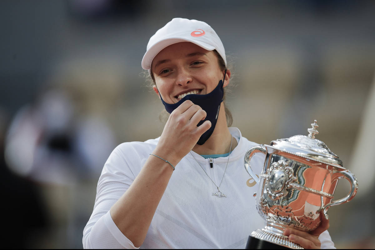 FILE - In this Saturday, Oct. 10, 2020 file photo, Poland's Iga Swiatek holds the trophy after ...