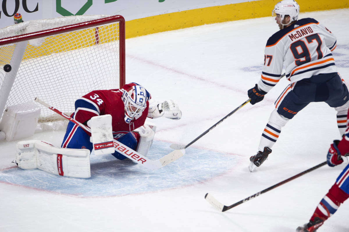 Edmonton Oilers' Connor McDavid (97) scores the winning goal on Montreal Canadiens goaltender J ...