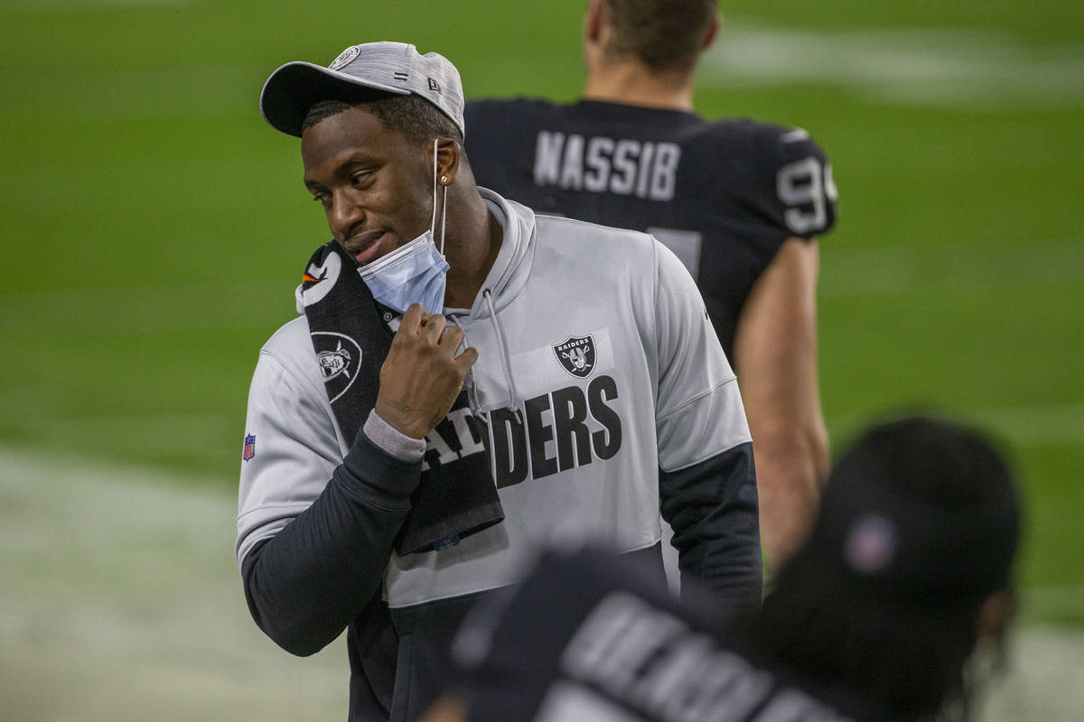 Raiders defensive end Clelin Ferrell pulls down his mask to talk during the first quarter of an ...