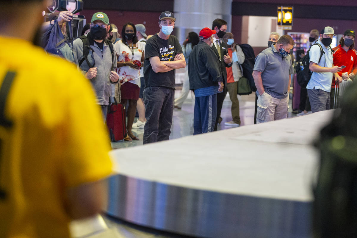 Travelers wait for their luggage at McCarran International Airport Terminal 1 in Las Vegas, Thu ...